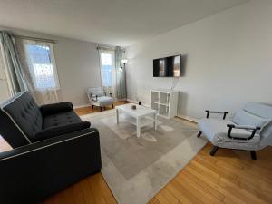 a living room with a couch and a table at Cozy Arbour Vacation Home - 8 beds 5 rooms in Kingston