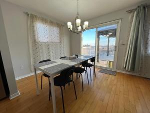 a dining room with a table and chairs and a window at ArbourRidge Vacation Home - 5 bedrooms sleeps 14 people in Kingston