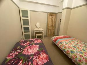 a bedroom with two beds and a mirror and a ladder at 2 Bed House in Barrow Hill Sleeps 4 in Hollingwood