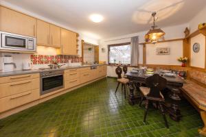 a large kitchen with a table and chairs in it at Ferienhaus am See in Zell am See