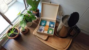 a wooden cutting board with plants on a table at Casa Alderotti in Bologna +28 photos