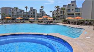 a large swimming pool in front of a resort at Luxury Beachfront Condo with Private Pool &Terrace in South Padre Island