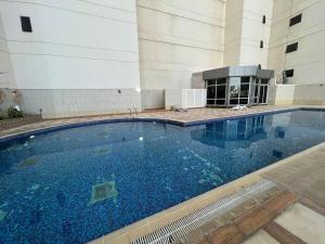 a large swimming pool in the middle of a building at Burj Al saadah Al mamzar sharjah in Sharjah