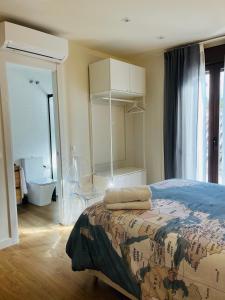 a bedroom with a bed with a map of the world on it at Casa Torre Hacho in Antequera