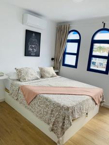 um quarto com uma cama e duas janelas em Bungalow Terrace&Pool near the Beach em Maspalomas