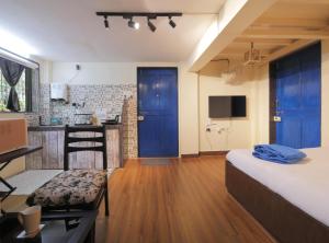 a hotel room with a bed and a kitchen and a room at Ranger - Bandra West in Mumbai