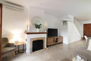 a living room with a fireplace and a tv at Villacana Community Family Beach Resort in Estepona