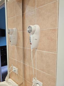 a shower with a blow dryer in a bathroom at Fiuggiamo House in Fiuggi +37 photos