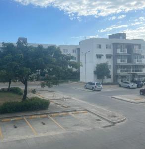 a parking lot with cars parked in front of a building at Residencial Terrazul in La Alianza