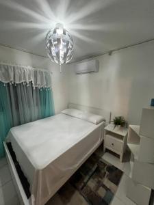a bedroom with a bed and a chandelier at Residencial Terrazul in La Alianza