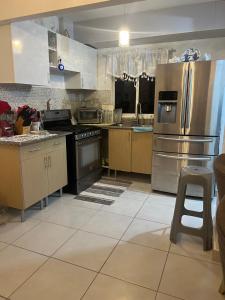a large kitchen with stainless steel appliances and cabinets at Residencial Terrazul in La Alianza