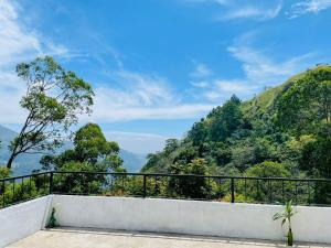 a balcony with a view of the mountains at Rock n Fall Nature Resort in Ella