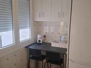 a kitchen with a table with a white appliance on it at Piso turistico LAURSI in Burgos