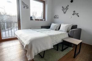 Postel nebo postele na pokoji v ubytování Rodinný apartmán v srdci Krkonoš