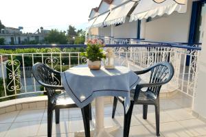 un tavolo e 2 sedie sul balcone di Leventis Apartments a Rovies