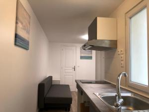 a small kitchen with a sink and a window at Loft entier parisien-Paris11 in Paris