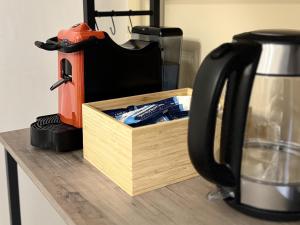a coffee maker sitting next to a wooden box on a counter at B&B I Mulini in Santa Maria del Molise