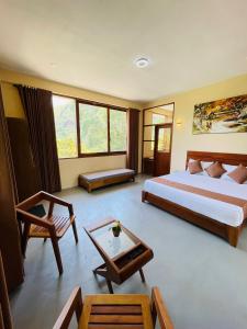 a hotel room with two beds and a table at Rock n Fall Nature Resort in Ella