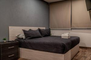 Ένα ή περισσότερα κρεβάτια σε δωμάτιο στο Loft Moderno Boulevard (suite 3)