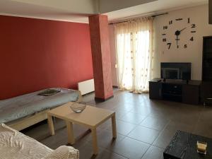 a living room with a bed and a table at Smile Stay Apartment in Alexandroupoli