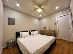 a bedroom with a bed with a ceiling fan at Bird Tiny House in Charming Japanese Garden in Homestead