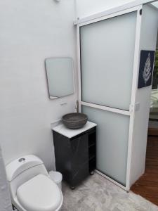 a bathroom with a toilet and a sink at Rainbow Glamping in Abejorral