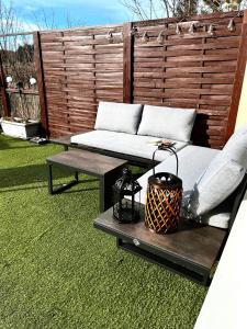 a patio with a couch and a table and a bench at Panoramic Aparthotel in Braunlage