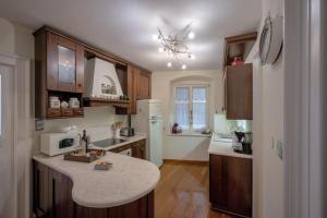 a kitchen with wooden cabinets and a white refrigerator at Central Square "Stone Pearl Heritage" Luxury Suite in Split