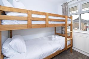 two bunk beds in a room with a window at Lancaster House in Stoke on Trent