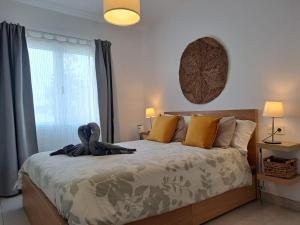 a bedroom with a bed with a swan on it at Luxury Sea View Senator Lanzarote in Costa Teguise