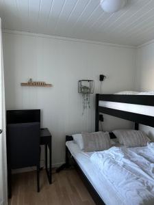 a bedroom with a bed and a desk in it at Apartment with beautiful panoramic view in Skulestadmo
