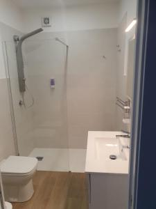 a bathroom with a shower and a toilet and a sink at GIANGY HOME in Casteldaccia