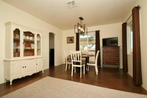 a dining room with a table and chairs and a television at Mayfair House - 4 Minutes to National Park! in Twentynine Palms
