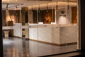 a glass wall in a room with a lobby at Dominium Palace in Agadir