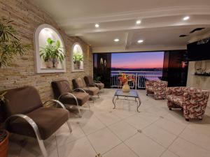 a waiting room with chairs and a large screen at HOTEL DAIFA in Florianópolis +55 photos