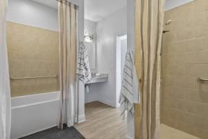 a bathroom with a shower and a shower curtain at Hotel Pass Christian King Suite 301 in Pass Christian