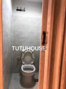 a bathroom with a toilet with the words toiletouse at TUTUhouse in Cairo