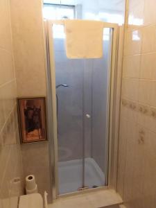 a shower with a glass door in a bathroom at IVY House in Edinburgh