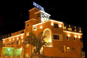 a hotel with a sign on top of it at night at HOTEL DAIFA in Florianópolis