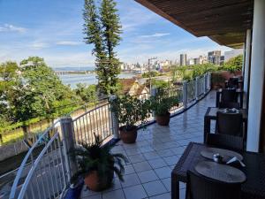 a balcony with a view of a river and a city at HOTEL DAIFA in Florianópolis