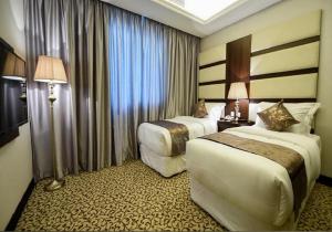 Postel nebo postele na pokoji v ubytování Verta Hotel Qouraish