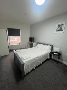 a bedroom with a large bed and a window at Luxury in luxury out in Nottingham