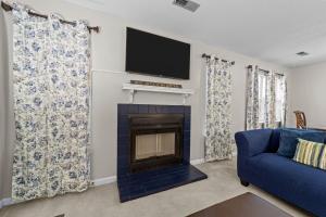 a living room with a fireplace and a tv at Comfortable Greensboro Condo in Greensboro