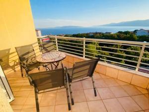 a patio with a table and chairs on a balcony at Apartment Tina in Rijeka