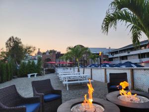 a patio with tables and chairs and a fire pit at The Shore Club in Spring Lake Heights