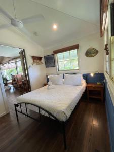 a bedroom with a large bed in a room at Grey Gum Lodge in Nimbin