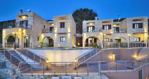 a large building with a skate park in front of it at Fotini Traditional Villas in Kavoúsion