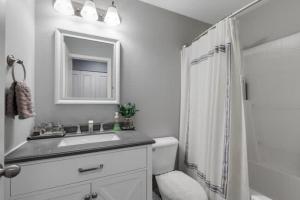 a white bathroom with a sink and a shower at Pet Friendly and Spacious Valley View Family Home in Snohomish