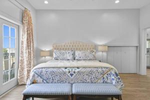 a bedroom with a bed with a blue and white bedspread at Hotel Pass Christian Penthouse in Pass Christian +12 photos