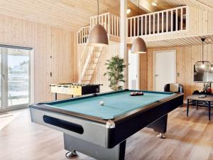 a billiard room with a pool table and a staircase at 22 person holiday home in Harbo re in Harboør